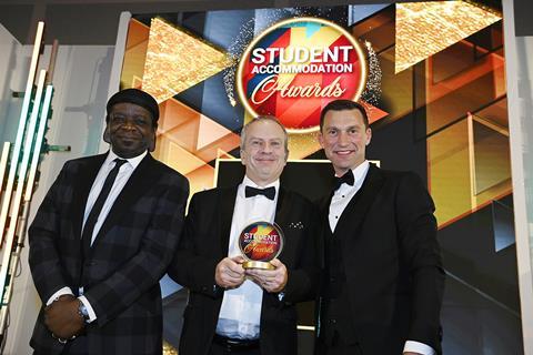 University Quarter's Richard Stott accepts the Collaboration trophy from Torsion Group's Dan Spencer