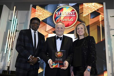 Mark Quigley accepts his Hall of Fame plaque from Naomi Ambrose of charity Talent Tap
